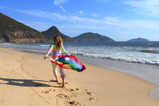 A woman runs along the beach with an Australian flag.  Love, Equality, Honeymoon, Vacation, 