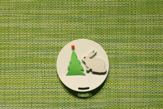 white hare near Christmas tree, conceptual image Christmas theme, flat lay, copy space,