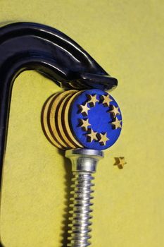 euro coin in the clamp  pressure after brexit, conceptual image crisis of the European Union