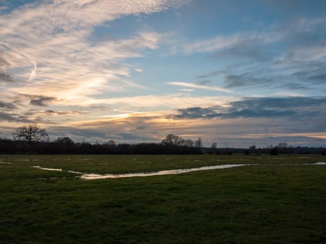 empty wet grass field low light sunset landscape dedham; essex; england; uk