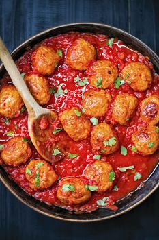 close up of rustic italian meatball in tomato sauce