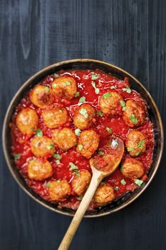 close up of rustic italian meatball in tomato sauce