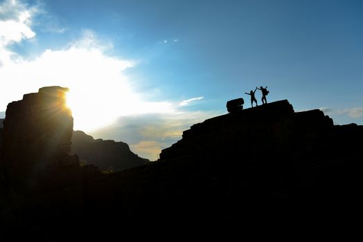 successful mountaineers on the summit rocks