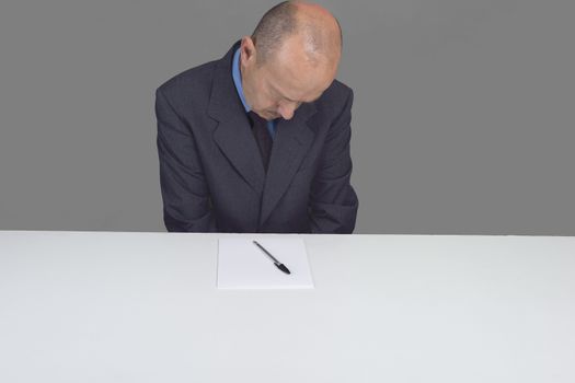 a worried man reads a document