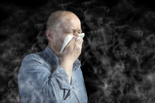 a man covers his mouth to protect himself from the smoke in the environment