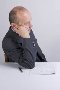 a worried man reading a document