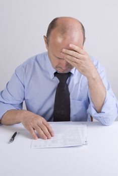 a worried man reading a document