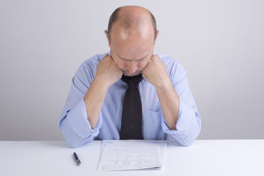 a worried man reading a document