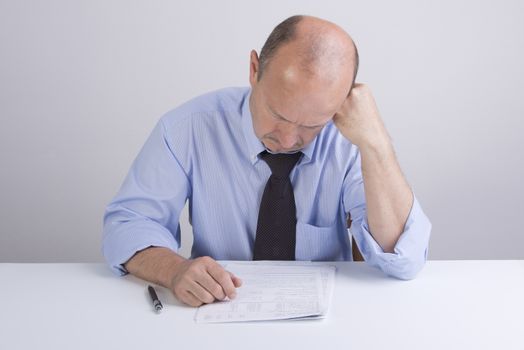 a worried man reading a document