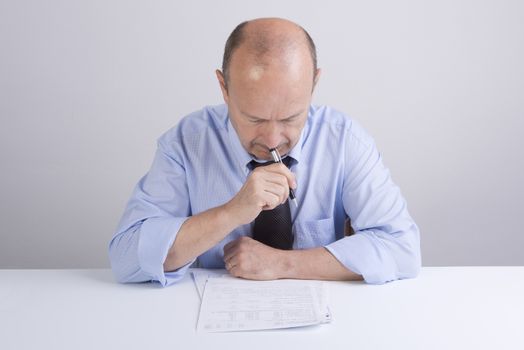 a worried man reading a document