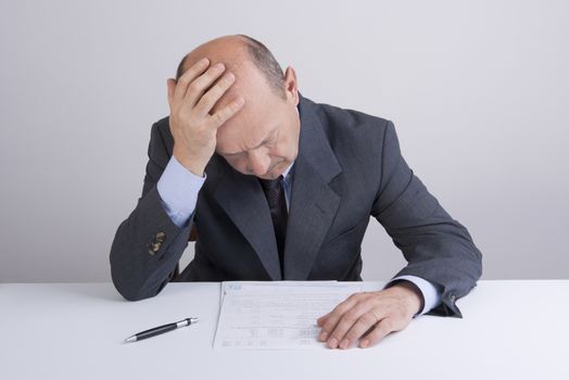 a worried man reading a document