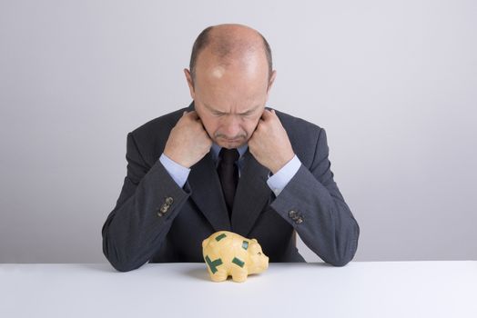 a desperate man as he tries to break the piggy bank