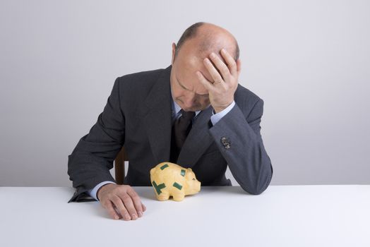 a desperate man as he tries to break the piggy bank