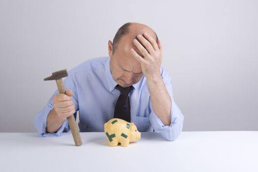 a desperate man as he tries to break the piggy bank