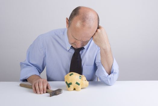 a desperate man as he tries to break the piggy bank