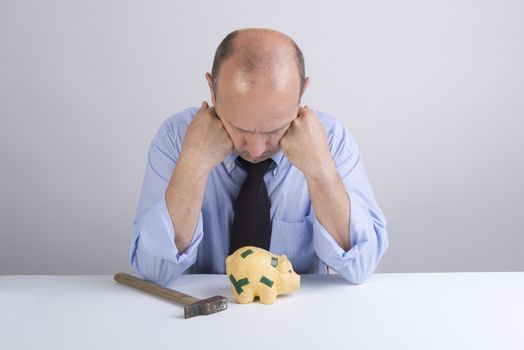 a desperate man as he tries to break the piggy bank