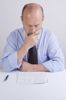 a worried man reading a document