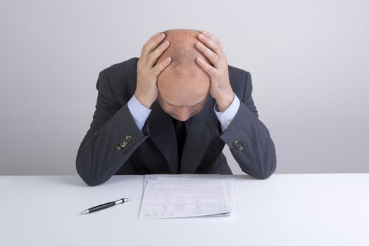 a worried man reading a document