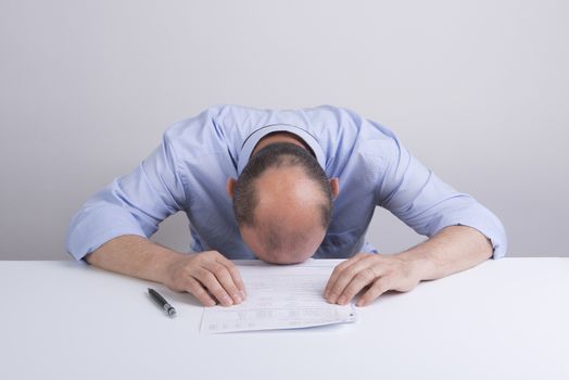 a worried man in front a document