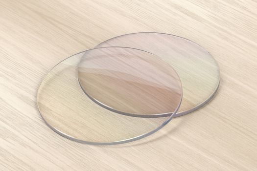 Pair of eyeglasses lens on wood background