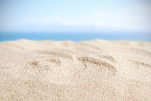 Sandy beach with blue sky background