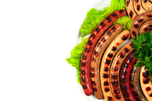 Closeup shot of a dish full of grilled sausages, isolated on white background. Flat lay