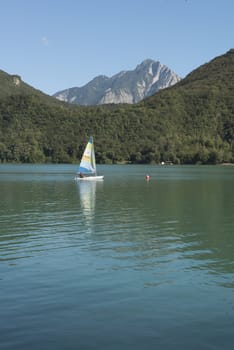 a sailboat in a mountain lake