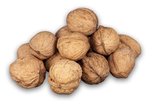 A stack of hard shells of walnuts piled together and isolated on white background