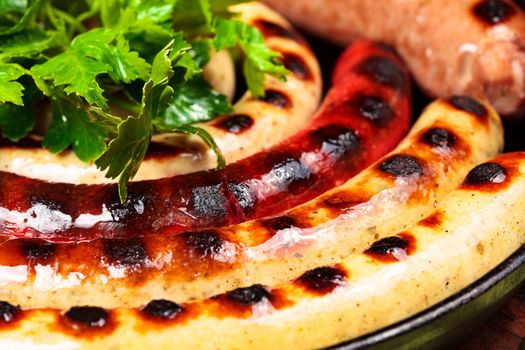 Closeup shot of sausages with green herbs on a dish