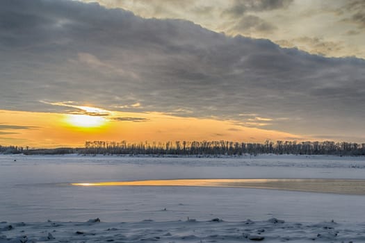 sunset on the river in winter river Dec frozen water forest