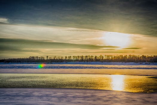 sunset on the river in winter river Dec frozen water forest