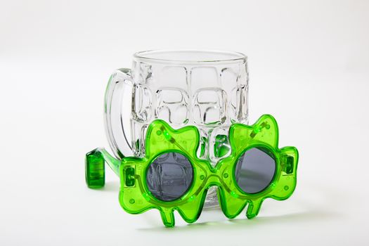 small pair of st-patties days sunglasses and an empty beer mug