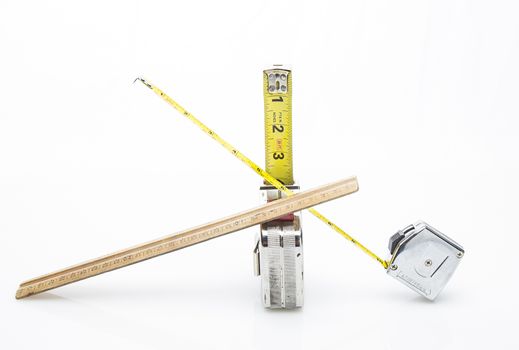 one wood ruler and two short tape mesuring tape isolated on a white background