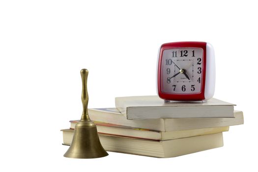 old clock and a bell with stack of books