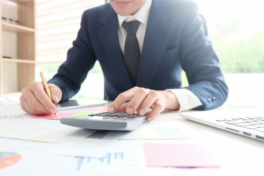 BusinessMan working with calculator, business document and laptop computer notebook, vintage ton