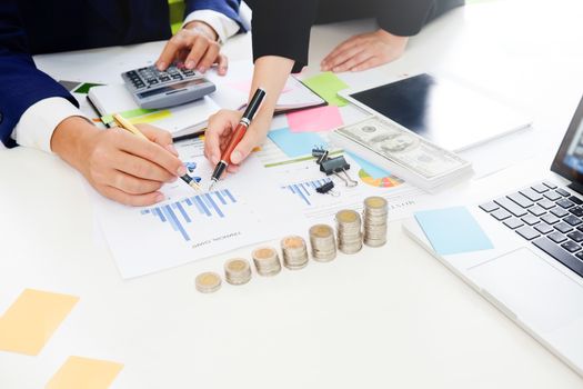 Business adviser analyzing financial,Financial planning Business man and Business woman talking to planner financial business, report finance in paper on office accounting.