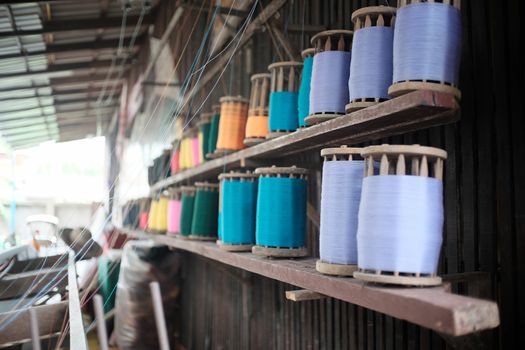 thread row on wood slat with selective focus.