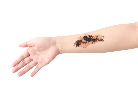 Woman's hand with scrub coffee grounds on skin hand and arm, beauty and healthy care concept