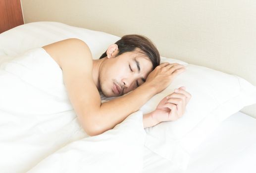 Closeup man sleeping on bed, health care and medical concept, selective focus