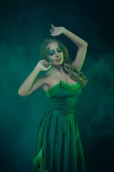 Fashion Art Portrait .Green Make-up and Colorful Bright Nails.