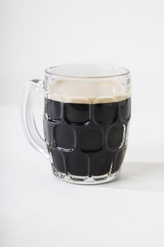 Stout black beer in a scuff mug