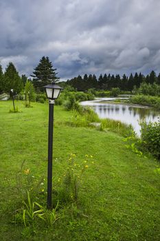 Series of crocked lamp post under dark stormy clouds