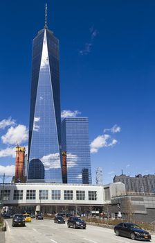 Street level view of the Freedom tower against a blue sky