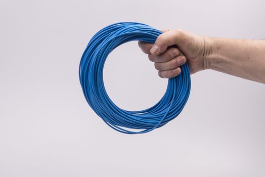 a skein of colored electric wire in hand