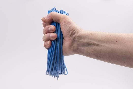 a skein of colored electric wire in hand