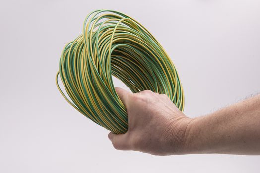 a skein of colored electric wire in the hand