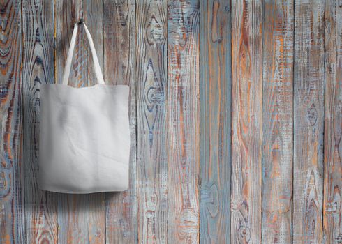 shopping bag of cotton weighs on the screw on wooden background