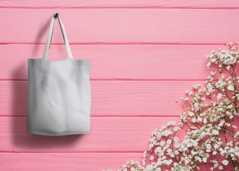 shopping bag of cotton weighs on the screw on wooden background