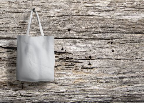 shopping bag of cotton weighs on the screw on wooden background