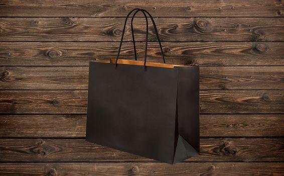 paper bag for shopping on a wooden background